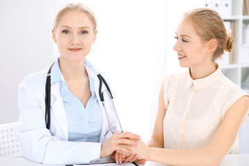 Doctor and  patient  sitting at the desk 