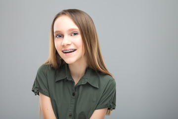 Beautiful young blonde girl with braces laughing