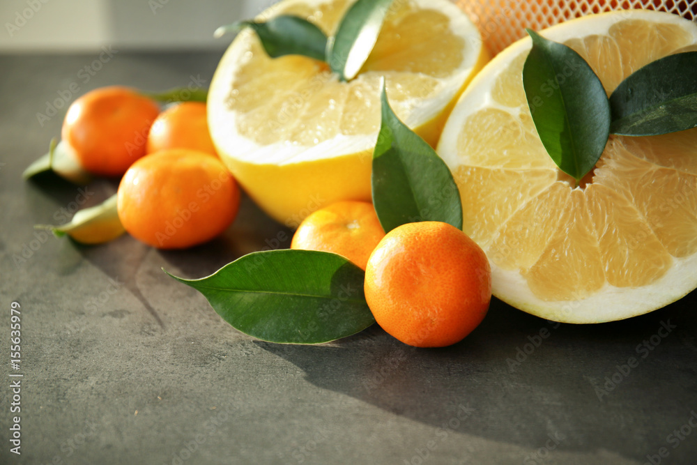 Halves of pomelo and fresh tangerines, closeup