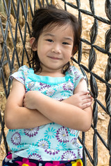 Wall Mural - Cheerful child enjoying and relaxing in hammock, outdoor on summer day.