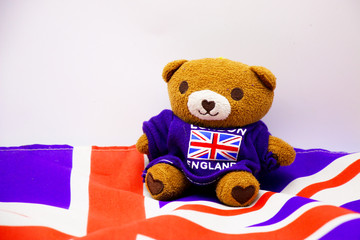 Wall Mural - Bear wears union jack shirt on white background