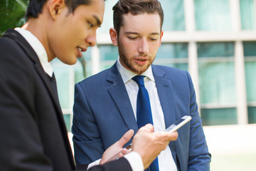 Canvas Print - Two Serious Business Men Using Smartphones Outside