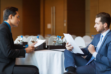 Wall Mural - Two Serious Colleagues Discussing Documents