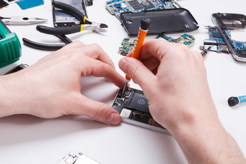 Poster - Repairman disassembling phone with screwdriver