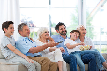 Canvas Print - Family watching tv on sofa
