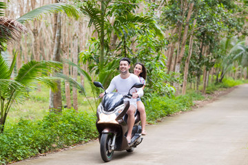 Wall Mural - couple riding motorcycle, young man woman happy smiling tourist travel bike tropical forest exotic v
