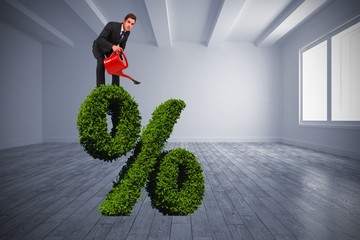 Poster - Composite image of businessman watering with red can