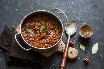 Slow cooker beef ragu. Crock pot braised beef on dark background. Delicious comfort healthy food