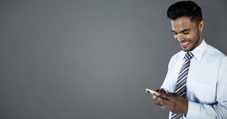 Poster - Composite image of smiling businessman using mobile phone
