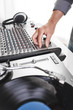© goodmanphoto - a dj using a turntable and mixing board