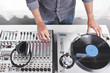 © goodmanphoto - a dj using a turntable and mixing board