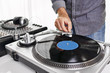 © goodmanphoto - a dj using a turntable and mixing board