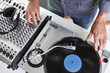 © goodmanphoto - a dj using a turntable and mixing board