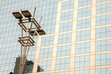 Lamp post in front of a Glass and concrete facade on a modern corporate skycraper building