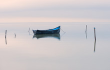 Old Rowboat On The Lake At Sunset