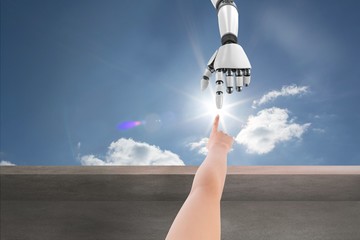 Poster - Human hands touching robot hand in blue sky background