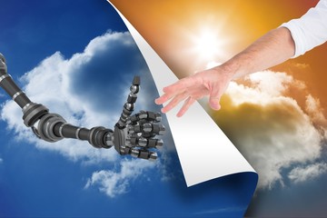 Wall Mural - Human and robot touching their hands between blue sky and sunset