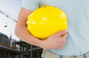 Canvas Print - Worker holding his hard hat on the construction office