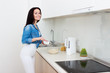 © Saksoni - Wellness concept. Beautiful young woman making breakfast and smiling. Healthy eating. Dieting concept.