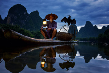 Wall Mural - Fisherman of Guilin, Li River and Karst mountains during the blue hour of dawn,Guangxi  China