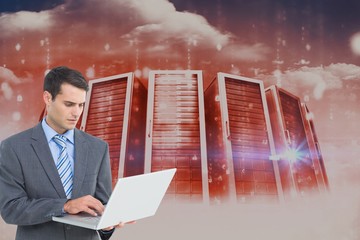 Poster - Business man is typing on the laptop against server background  