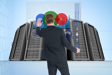 Canvas Print - Business man from the back against data center 