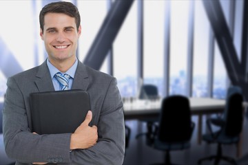 Poster - businessman holding a notebook against office background 