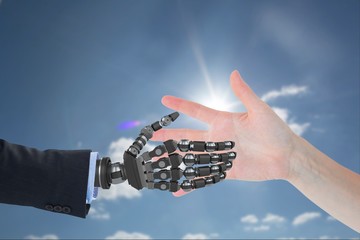 Poster - human hand is touching robot hand against sky background