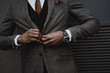 © LIGHTFIELD STUDIOS - confident stylish businessman wearing suit outdoors at wall