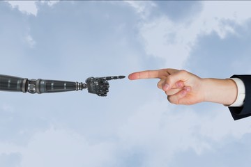 Poster - a business man is touching robot hand against sky background