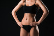 © master1305 - Muscular young woman athlete on black