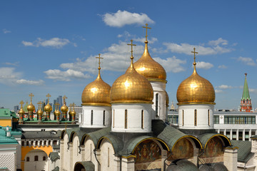 Wall Mural - Golden domes of Assumption Cathedral of Moscow Kremlin on blue sky background . Russia