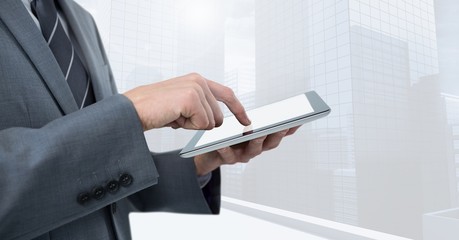 Poster - Businessman touching tablet by bright window