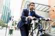 © Sergey Nivens - Young businessmen with a bike