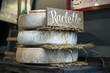 the Maturing Raclette cheese with tag on the farmer market