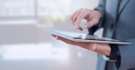 Poster - Businessman holding tablet in bright office