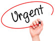 © netsay - Man Hand writing Urgent with black marker on visual screen.
