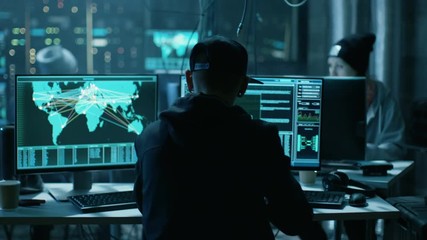 Aufkleber - Team of Internationally Wanted Hackers Teem Organize Advanced Virus Attack on Corporate Servers. Place is Dark and Has Multiple displays. Shot on RED EPIC-W 8K Helium Cinema Camera.