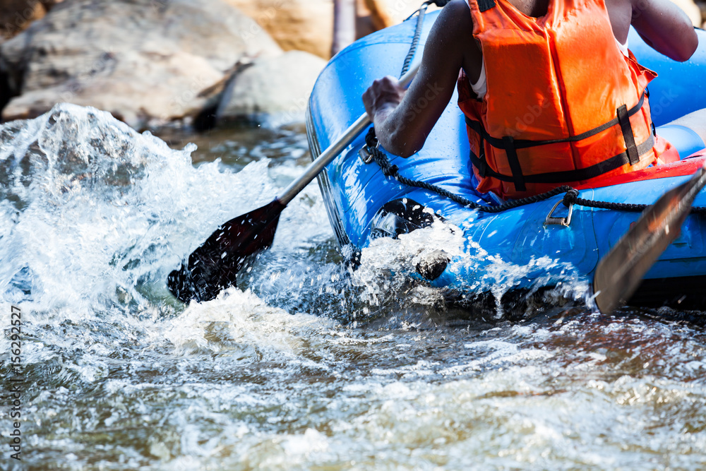 Close-up of young person rafting on the river, extreme and fun sport at tourist attraction - obrazy, fototapety, plakaty 