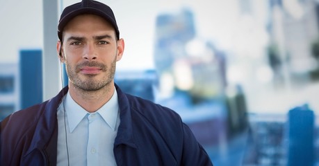 Wall Mural - Security guard against blurry window showing city