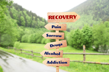 rehabilitation concept. wooden signboards pointing different directions to recovery and addiction on