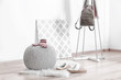 © Africa Studio - Knitted pouf with clothes in modern hall interior