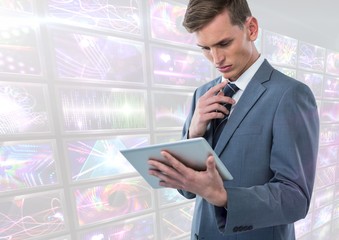 Poster - Businessman holding tablet with bright colorful screens visuals