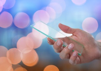 Poster - Hand holding glass device with sparkling light bokeh background
