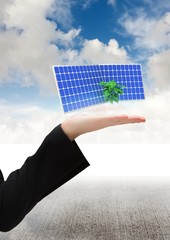 Canvas Print - solar panel on hand of a business woman. Floor and sky