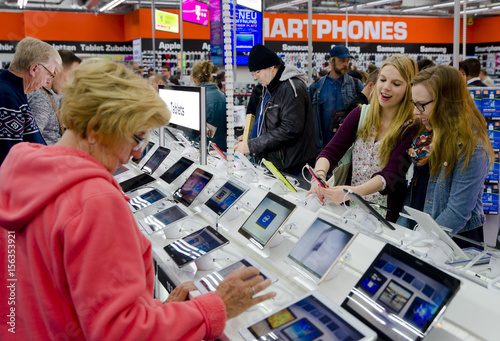 People Look At Tablet Computers At Saturn Electronic Retailer In