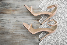 Beige Sandals With Heels On A Light Background With White Lace