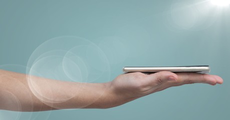 Poster - Hand with phone on palm against blue background with flare