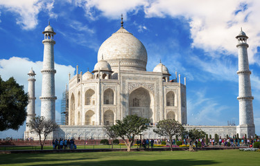 Fototapete - Historic Taj Mahal with blue sky and clouds - A white marble mausoleum designated as the UNESCO World heritage site.
