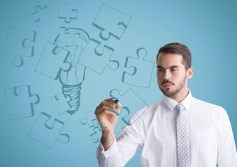 Wall Mural - Business man drawing jigsaw doodle against blue background